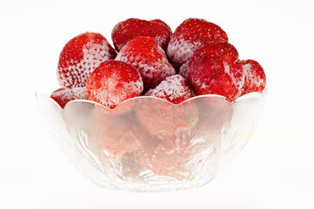 Strawberry sliced in a glass holder, isolated on white backgroundの写真素材
