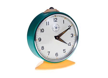Old metal alarm clock on a white background.