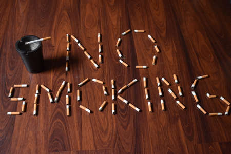 No smoking written on the floor with used cigarettes 12.5.2020