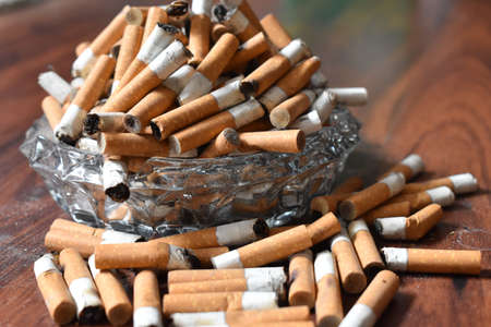 Ashtray overloaded with used cigarettes 12.5.2020の写真素材