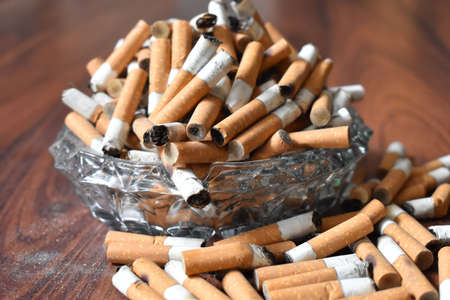 Ashtray overloaded with used cigarettes 12.5.2020の写真素材