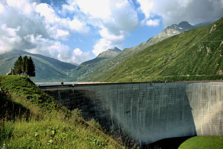 Wall of an alpine reservoir on top of the Lukmanierpass in Switzerland 30.7.2020の写真素材