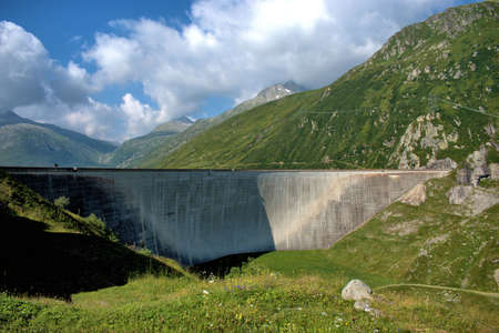 Wall of an alpine reservoir on top of the Lukmanierpass in Switzerland 30.7.2020の写真素材