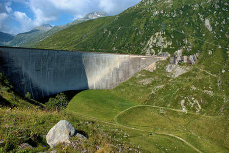 Wall of an alpine reservoir on top of the Lukmanierpass in Switzerland 30.7.2020の写真素材