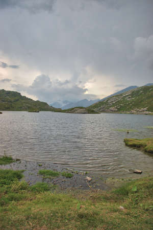 Upcoming storm over the alpine lake on top of the San Bernardinopass in Switzerland 30.7.2020の写真素材