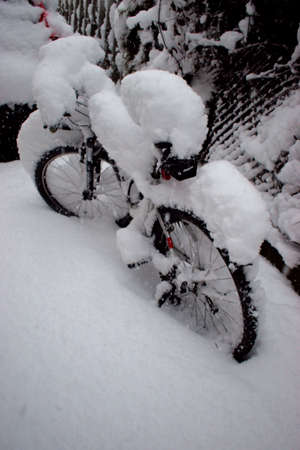 Heap of fresh snow was falling on a bike in Vaduz in Liechtenstein 14.1.2021のeditorial素材