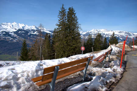 Empty bench in the winter time in the alps in Liechtenstein 19.2.2021の写真素材
