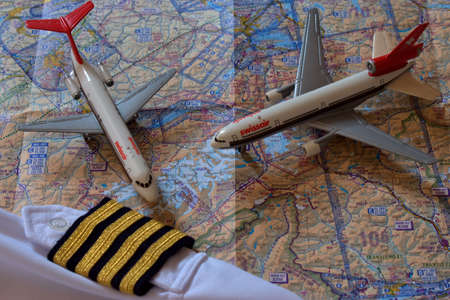 Aircraft toys on an air navigation map and golden captain stripes 25.3.2021のeditorial素材