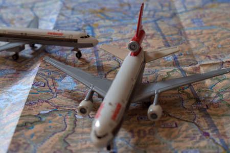 Swissair aircraft toys positioned on an air navigation map 25.3.2021