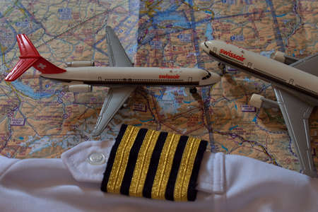 Aircraft toys on an air navigation map and golden captain stripes 25.3.2021のeditorial素材