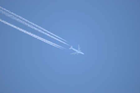 Aircraft with contrails in the blue sky over Switzerland 21.4.2021のeditorial素材