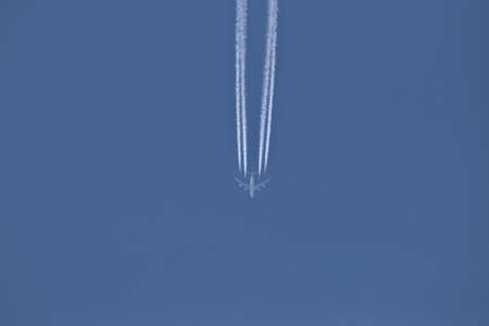 Aircraft with contrails in the blue sky over Switzerland 20.4.2021