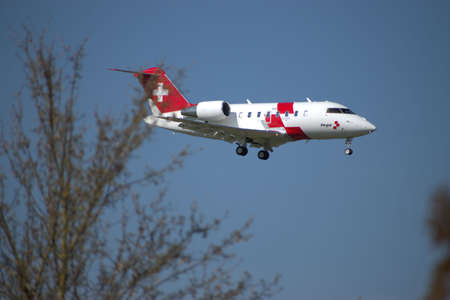 Rega ambulance jet Bombardier CL 600 2B16 on the final approach to the international airport in Zurich in Switzerland 24.4.2021のeditorial素材