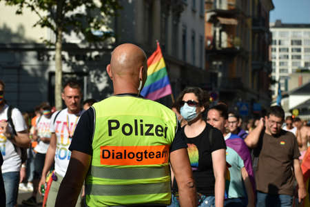 ZURICH, SWITZERLAND, SEPTEMBER 4, 2021 Police officer takes care of the peaceful protesters during a gay pride demo in the city centerのeditorial素材