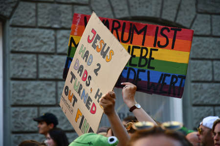 ZURICH, SWITZERLAND, SEPTEMBER 4, 2021 Protesters in the city center holding up their sign with a...