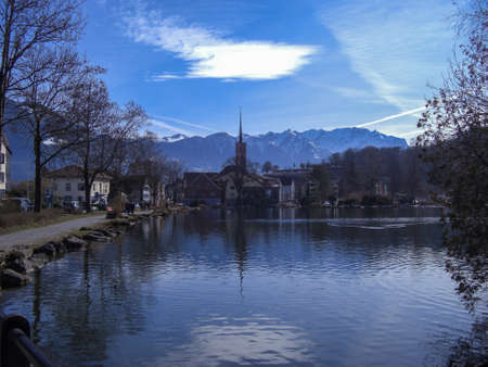Werdenberg, Switzerland February 26, 2019 Heavenly view over the lake with traditional old buildings in the background and snow covered mountainsのeditorial素材