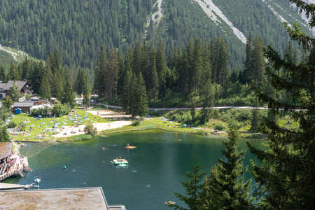 Arosa, Switzerland, August 15, 2021 Lake view in an alpine scenery with trees