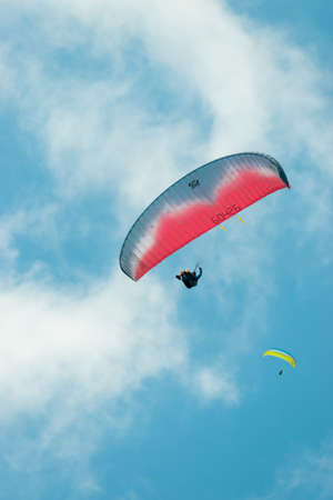Appenzell, Switzerland, June 13, 2021 Parachute is gliding in the blue sky over the swiss alpsのeditorial素材
