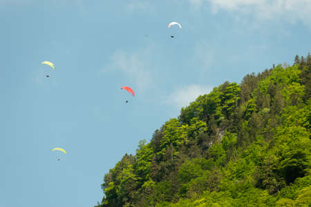 Appenzell, Switzerland, June 13, 2021 Parachute is gliding in the blue sky over the swiss alpsのeditorial素材