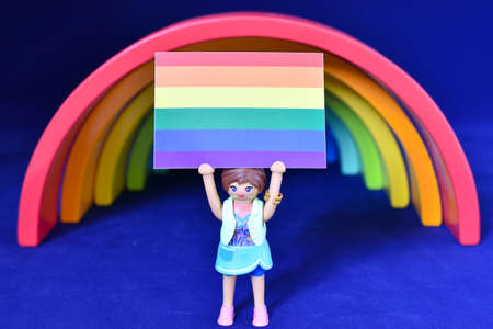 Vaduz, Liechtenstein, October 15, 2021 Colorful rainbow with a human toy holding up a gender flag