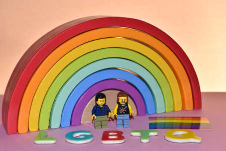 Vaduz, Liechtenstein, October 17, 2021 Colorful rainbow with a human toy gay pair on a pink backgroundのeditorial素材