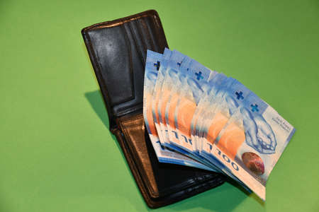 Vaduz, Liechtenstein, November 22, 2021 Some one hundred bills in the swiss currency on a wallet