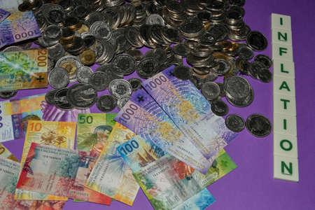 Vaduz, Liechtenstein, November 22, 2021 Swiss currency bills in cash with the word inflationの写真素材