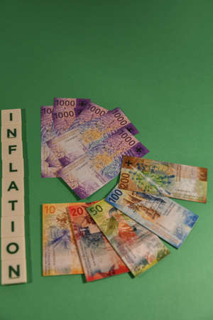 Vaduz, Liechtenstein, November 22, 2021 Toy bills in the swiss currency and the word inflation on a...
