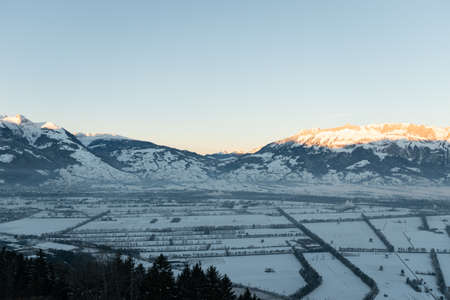 Planken, Liechtenstein, January 13, 2022 Terrific swiss mountain panorama and the rhine valley in the early morning in winter timeの写真素材