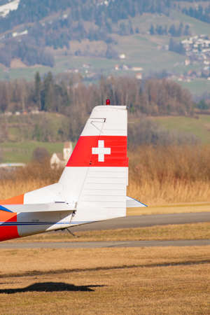 Wangen-Lachen, Switzerland, February 13, 2022 Swiss cross on the tail of a AS-202 Bravo propeller...
