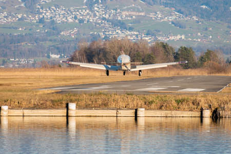 Wangen-Lachen, Switzerland, February 13, 2022 Mooney M20K-231 on its final approach to a small...