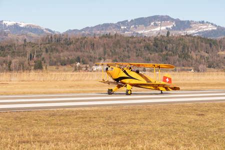 Wangen-Lachen, Switzerland, February 13, 2022 Bucker BU-131 double decker propeller plane is taxiing on a small airfieldのeditorial素材