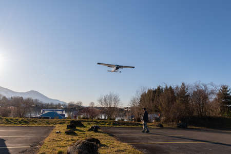 Wangen-Lachen, Switzerland, February 13, 2022 Cessna F152 airplane is approaching to a small...