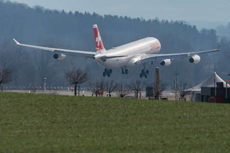 Zurich, Switzerland, February 24, 2022 Swiss International Airlines Airbus A340-313 aircraft is arriving on runway 14のeditorial素材