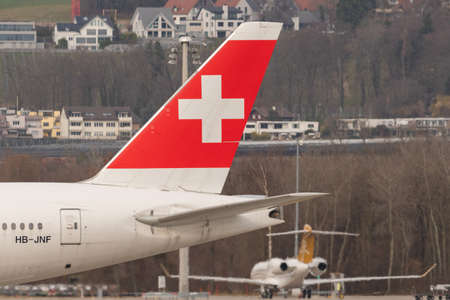 Zurich, Switzerland, February 24, 2022 Swiss cross on the rudder of a Boeing 777-300ER aircraftのeditorial素材