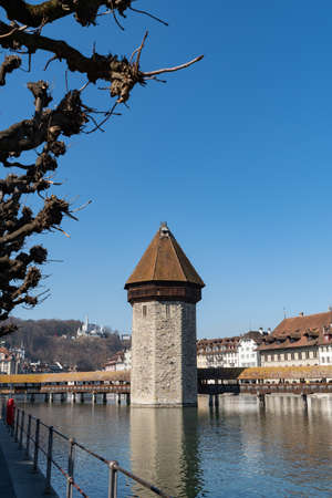 Lucerne, Switzerland, March 10, 2022 Tower of the popular old chapel bridge and most interesting landmark in the city centerのeditorial素材