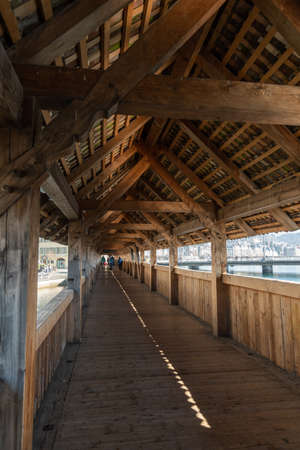 Lucerne, Switzerland, March 10, 2022 Pedestrian walkway inside the famous old and wooden chapel bridge in the city centerのeditorial素材