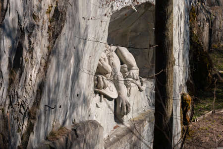 Lucerne, Switzerland, March 10, 2022 Popular lion monument carved into a rock in a little park in the city centerのeditorial素材