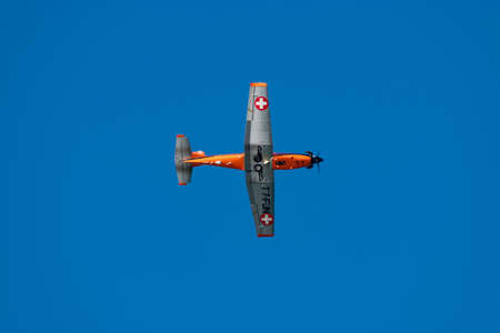 Wangen-Lachen, Switzerland, February 27, 2022 Pilatus PC-7 propeller plane from below in the blue...