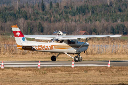 Wangen-Lachen, Switzerland, February 27, 2022 Cessna 152 propeller plane is taxiing on a small...