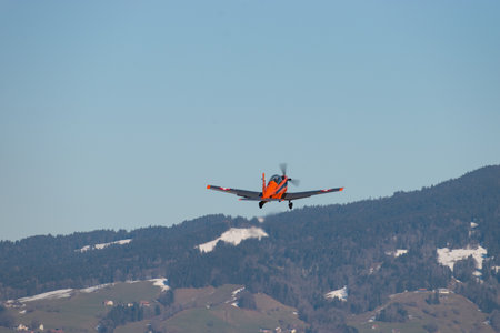 Wangen-Lachen, Switzerland, February 27, 2022 Pilatus PC-7 propeller plane is departing from a small...