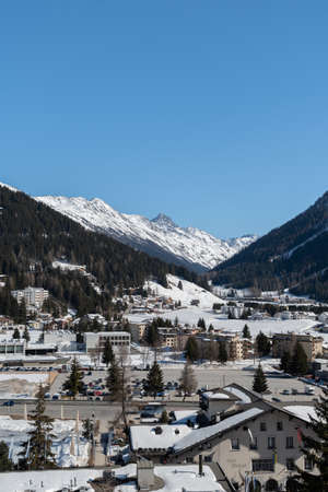 Davos, Switzerland, March 23, 2022 View over the city and the stunning snow covered alps on a clear blue sky dayのeditorial素材