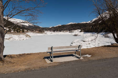 Davos, Switzerland, March 23, 2022 Place to have a rest at the majestic frozen lake in an incredible winter landscape scenery on a sunny dayの写真素材