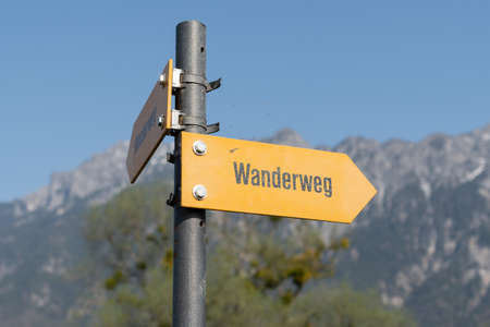 Vaduz, Liechtenstein, March 28, 2022 Hiking trail written in german on a direction signの写真素材