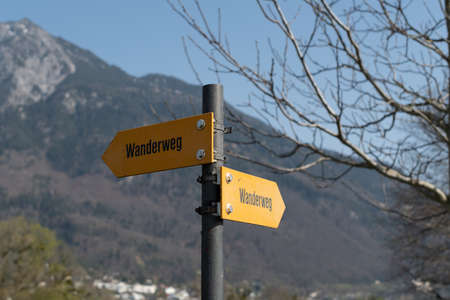 Vaduz, Liechtenstein, March 28, 2022 Hiking trail written in german on a direction signの写真素材