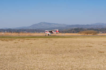 Wangen-Lachen, Switzerland, March 27, 2022 Piper PA22-150 Caribbean propeller plane is landing on a small airfieldのeditorial素材