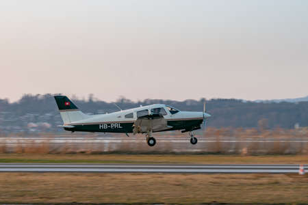 Wangen-Lachen, Switzerland, March 27, 2022 Piper PA28-161 Warrior III propeller plane is landing on a small airfieldのeditorial素材