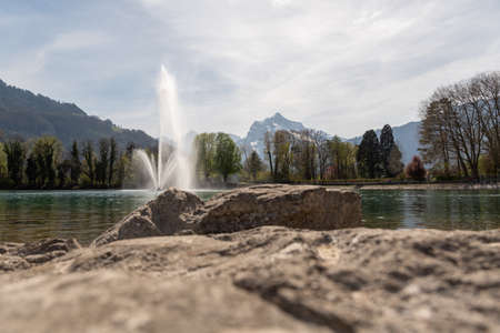 Weesen, Switzerland, April 13, 2022 Water fountain at the lake of Walensee in spring time