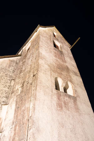 Berschis, Switzerland, April 13, 2022 Illuminated Saint Georges chapel on the top of a hill at nightの写真素材