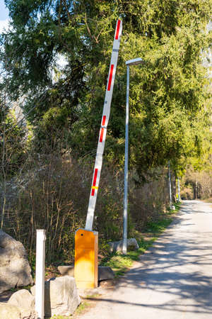 Schaan, Liechtenstein, April 4, 2022 Open barrier on a small street in a forest